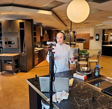 Chef Andrew Forlines in a retail home kitchen appliance showroom recording a video podcast episode.