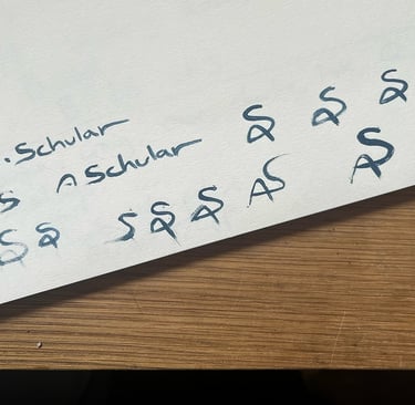 Practicing new signatures over and over on a piece of scrap paper