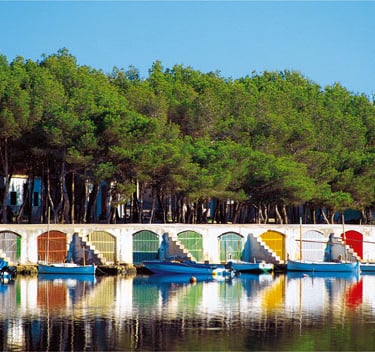 a row of boats in a row on the water