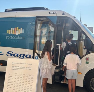Passengers boarding a Sagales bus for the Portocolom Felanitx shuttle service at a sunny Mediterranean stop.