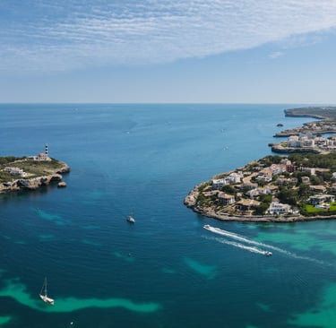 a boat sailing in the mediterranean sea near a Portcolom port