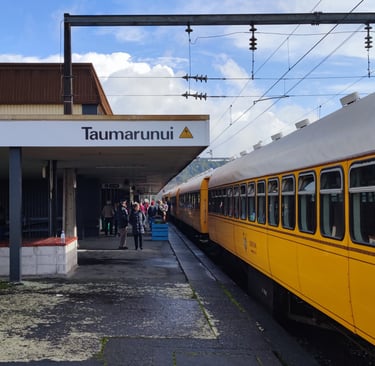 a yellow train is parked at Taumarunui train station