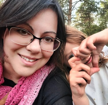 Doula Valentina -me- a woman in glasses and a pink scarf around her neck