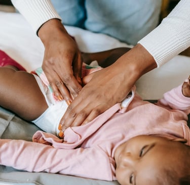 a woman is holding a baby in her lapel