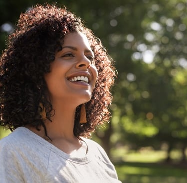 A woman smiling and looking up and enjoying life with peace, happiness and contentment