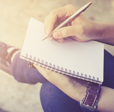 Person writing their personal growth goals
