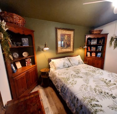a bed room with a bed and a book shelf brass accents antique furniture