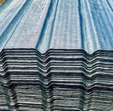 a stack of corrugated steel sheets with a blue sky background
