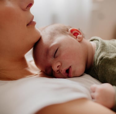 a woman holding a baby in her arms