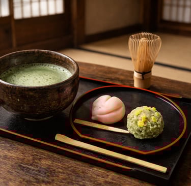 Authentic Japanese tea ceremony still life featuring matcha bowl, wagashi confectionery, bamboo whis
