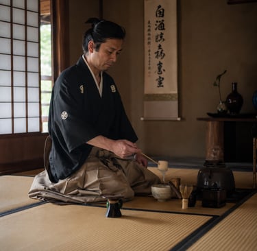 A man in a traditional Japanese kimono performs a tea ceremony on a tatami mat.