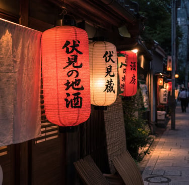 Traditional red and white Japanese paper lanterns with calligraphy glowing outside a restaurant in Kyoto at night.
