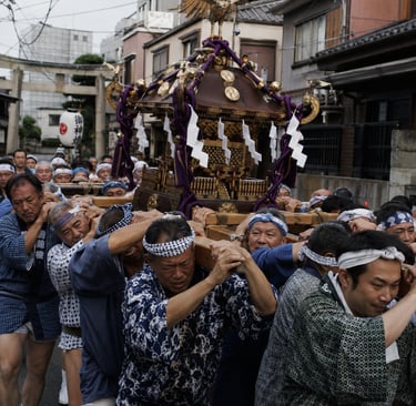Participants carry a traditional Mikoshi portable shrine during a Japanese Shinto festival parade.