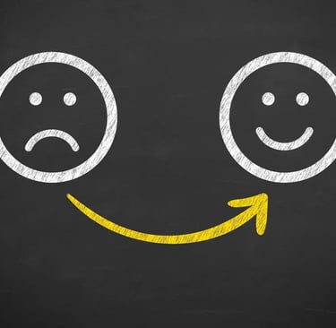 a smiley face drawn on a chalkboard with a smiley face