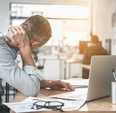 Small business owner buried in paperwork, overwhelmed before Cilson Bookkeeping help