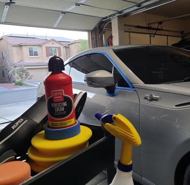 Car being masked with painter’s tape in preparation for professional paint correction in Las Vegas