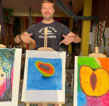 a man standing in front of a display of art work