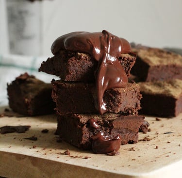 a stack of chocolate brownies with chocolate frosting