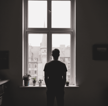 Man at a window in the morning