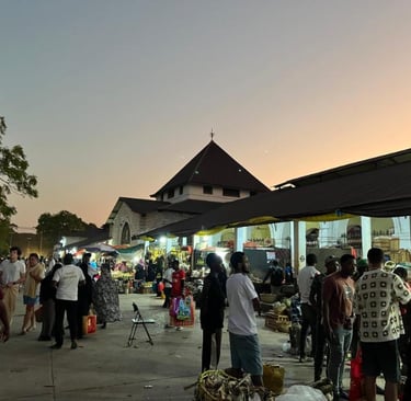 Darajani Market in Stone Town Zanzibar during the evening with locals shopping for spices, fruits, and fresh seafood