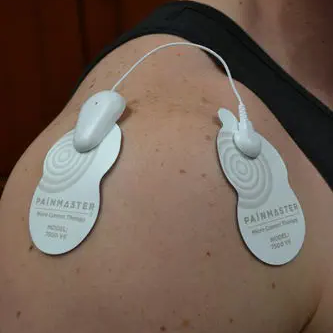 Man wearing Painmaster patches on his shoulder.