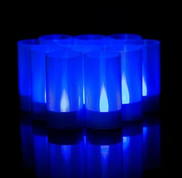 Set of frost‑blue LED ritual candles glowing with cold light, styled for horror décor and occult