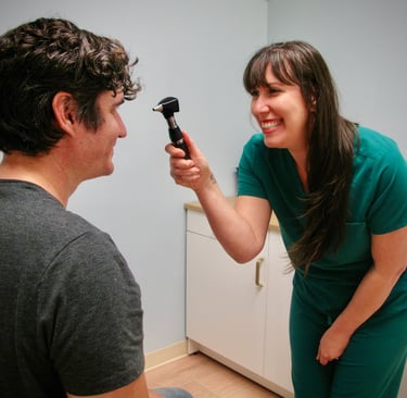 A smiling doctor examines a patient