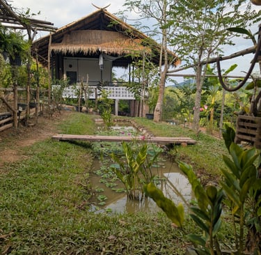 Open-air teahouse at Loei Valley overlooking lotus pond and orchard garden