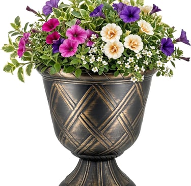 A decorative bronze garden urn filled with purple, pink, and white petunias and variegated green foliage.