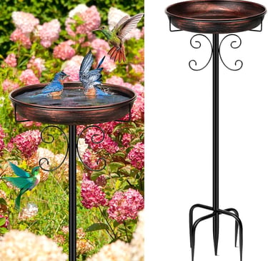 A decorative copper bird bath on a black metal stand with hummingbirds and bluebirds in a flower garden.