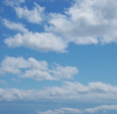 Beautiful baby blue sky with big white cumulus clouds