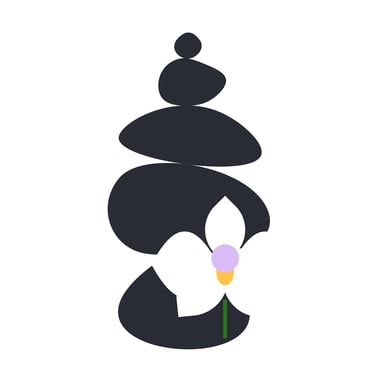 A black rock cairn with a white orchid which has a lavender & tangerine center