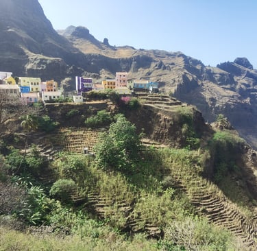 Colorful houses on a steep terraced mountain slope overlooking the Atlantic coast in Cape Verde.