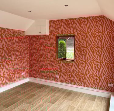 Bold orange and red patterned feature wall in Hove Sussex, statement interior wall design