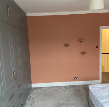 Pink feature wall with fitted wardrobes in Worthing Sussex, professional bedroom painting