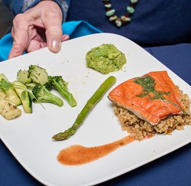 Tender Sous Vide Wild Salmon with Spiced Steamed Vegetables, Avocado Relish, and Quinoa Pilaf. 