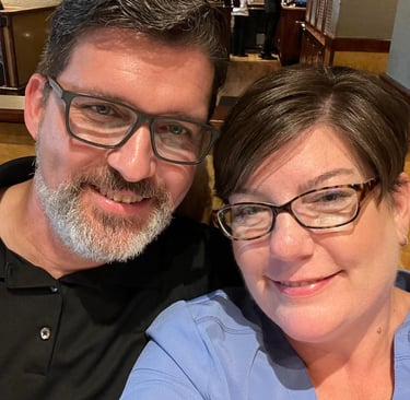 a man and woman smiling and posing for a picture