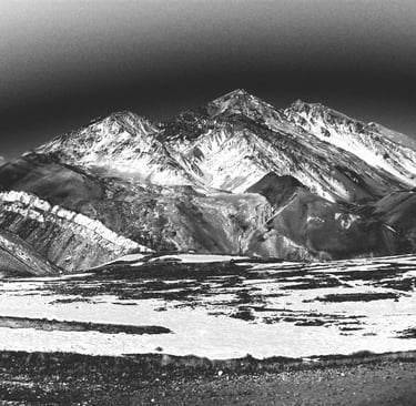 a black and white photo of a mountain range