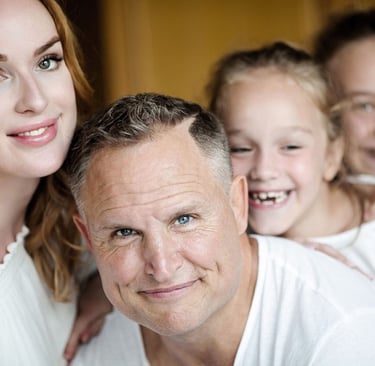 a man and two children posing for a family portrait on koh samui