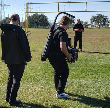 Video content production onsite on a football field with a player.