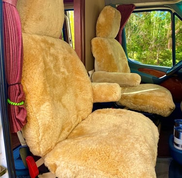 Plush tan sheepskin seat covers installed on motorhome captain chairs for luxury comfort.