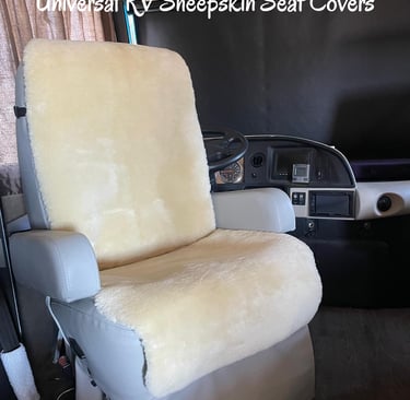 Cream universal sheepskin seat covers installed on a motorhome driver seat for RV comfort.