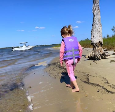 little girl exploring the beach of the Choctawhatchee bay