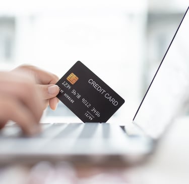 Person using a credit card while online shopping with a Laptop computer