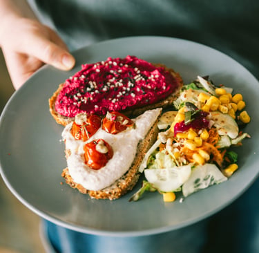 Savory plate with gourmet toast and a fresh salad.