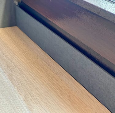 a wooden table with a wooden table top and a window