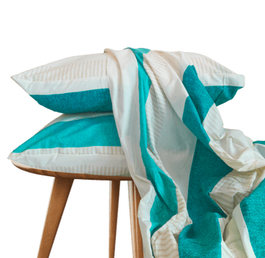 a stack of pillows and a bedsheet on a stool - cotton bedsheet