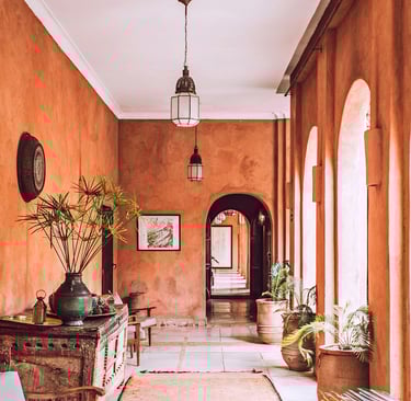a welcome hallway with a large rug and a wooden table at reception. Guest Experience Enhancement