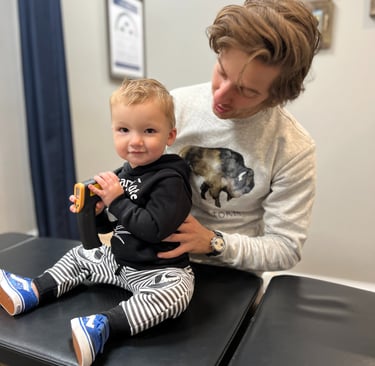 Smiling baby after a gentle chiropractic adjustment at Three Nails Chiropractic