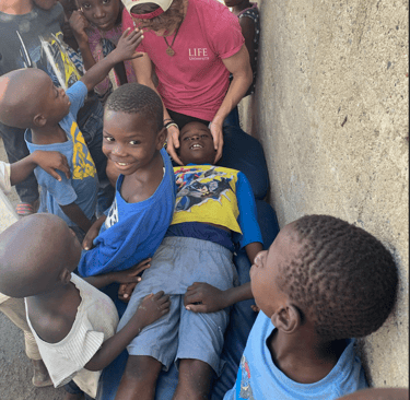 Dr. Spencer doing gentle pediatric adjustments an a faith trip to Haiti.
